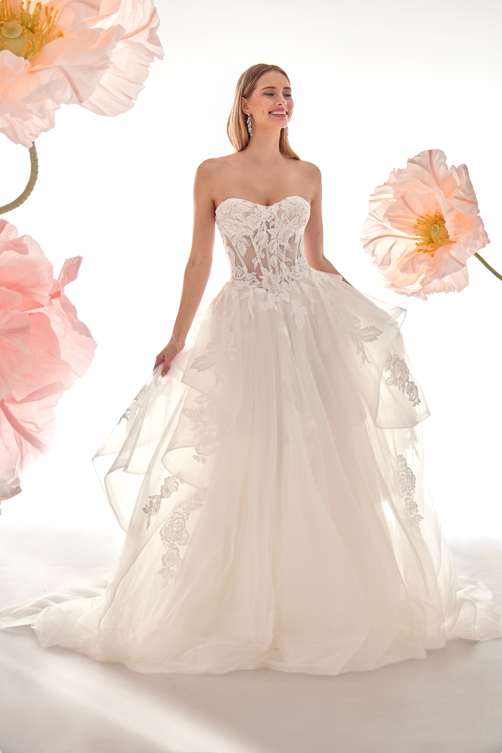 Woman in a white wedding dress surrounded by pink flowers on a white background
