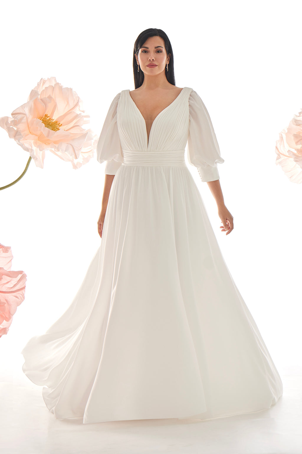 Woman wearing a white wedding dress with floral elements in the background