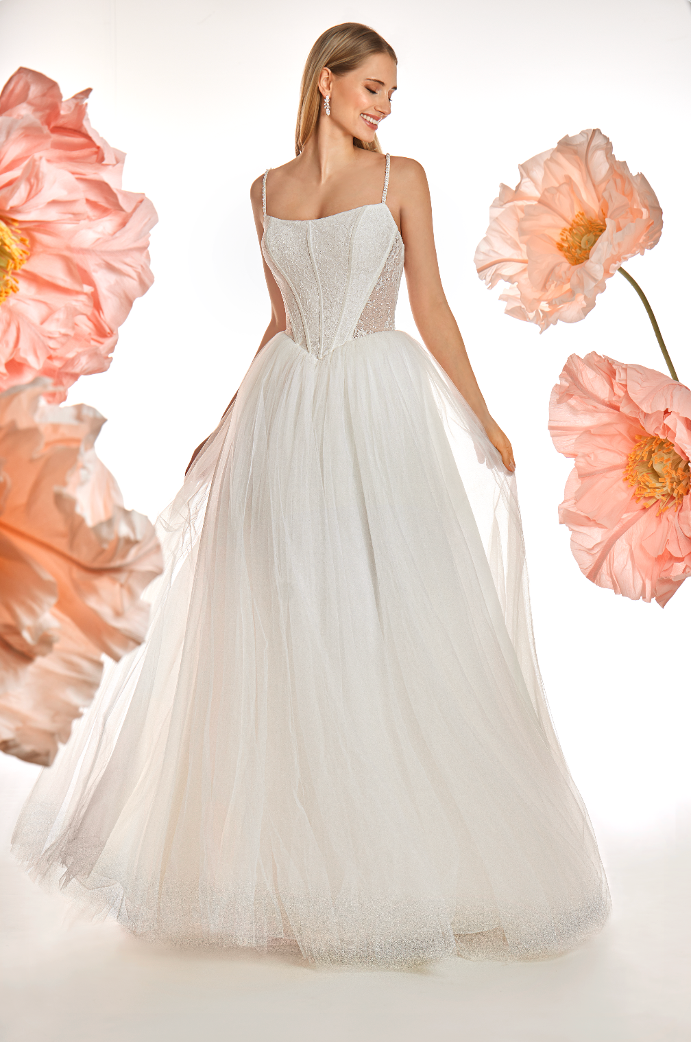 Woman in a white wedding dress surrounded by pink flowers on a white background